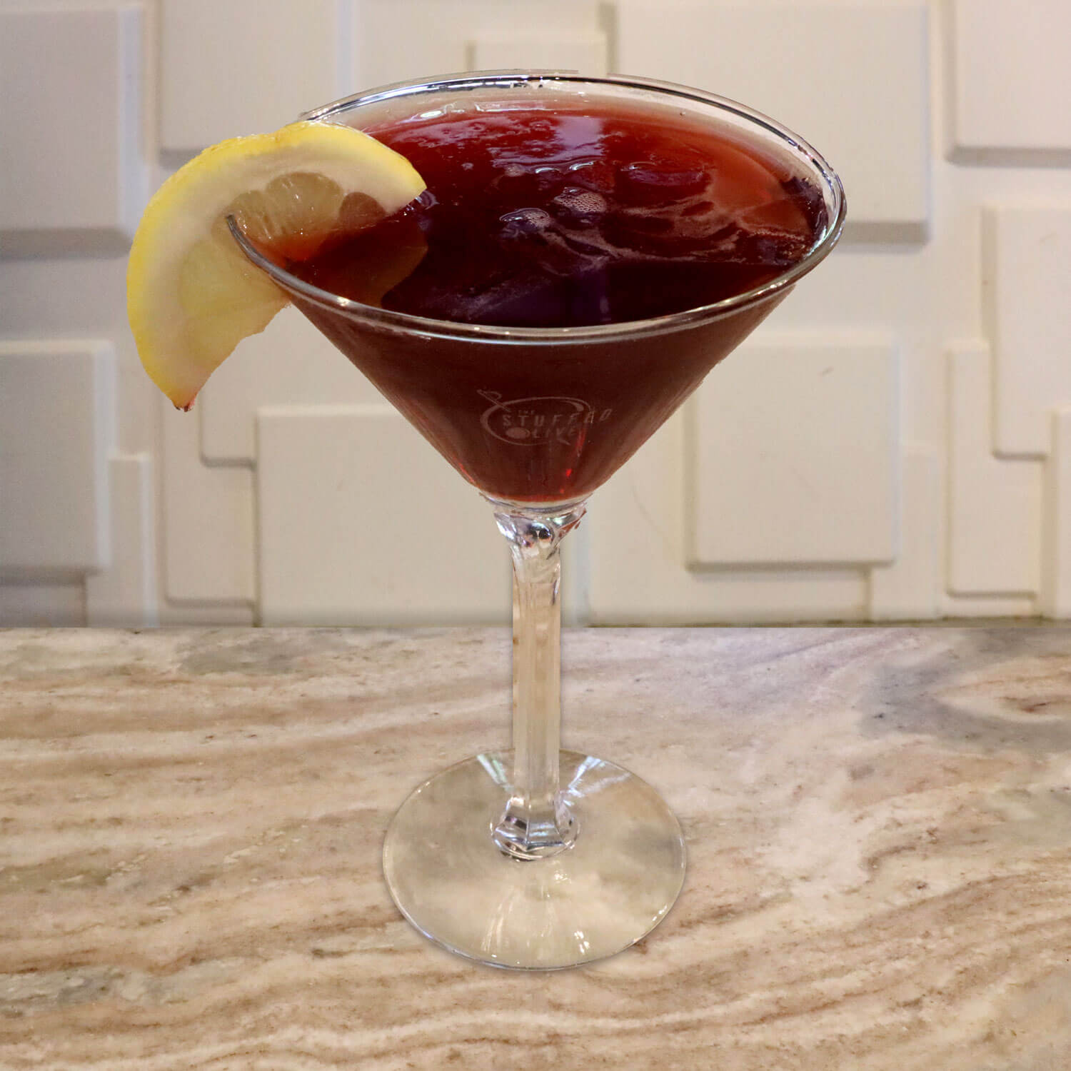 Limoncello, Raspberry Schnapps, and Sour. Garnished With a Lemon Slice