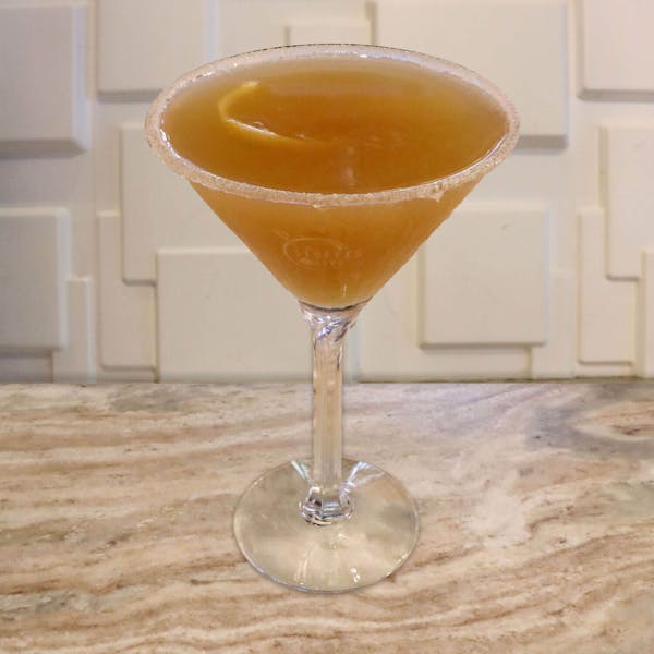 Hennessy, Grand Marnier, Simple Syrup and Lemon Juice. Garnished With a Sugar Rim and Lemon Twist