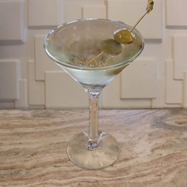 Premium Gin, Dry Vermouth, splash of Scotch Whiskey. Garnished with a lemon twist or your choice of stuffed olives
