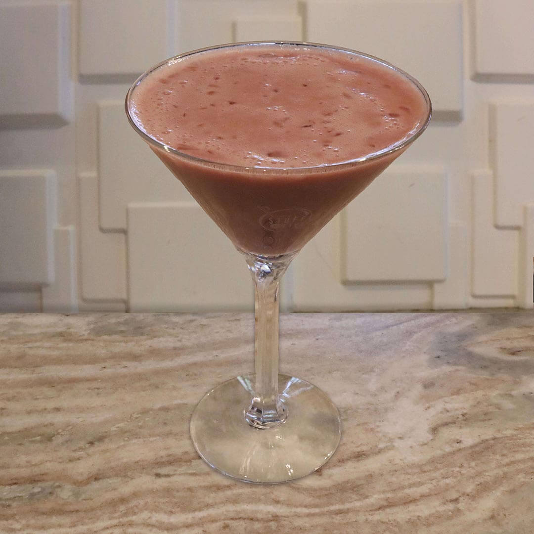 A thick, dark reddish-brown chocolate raspberry cocktail served in a chilled glass.
