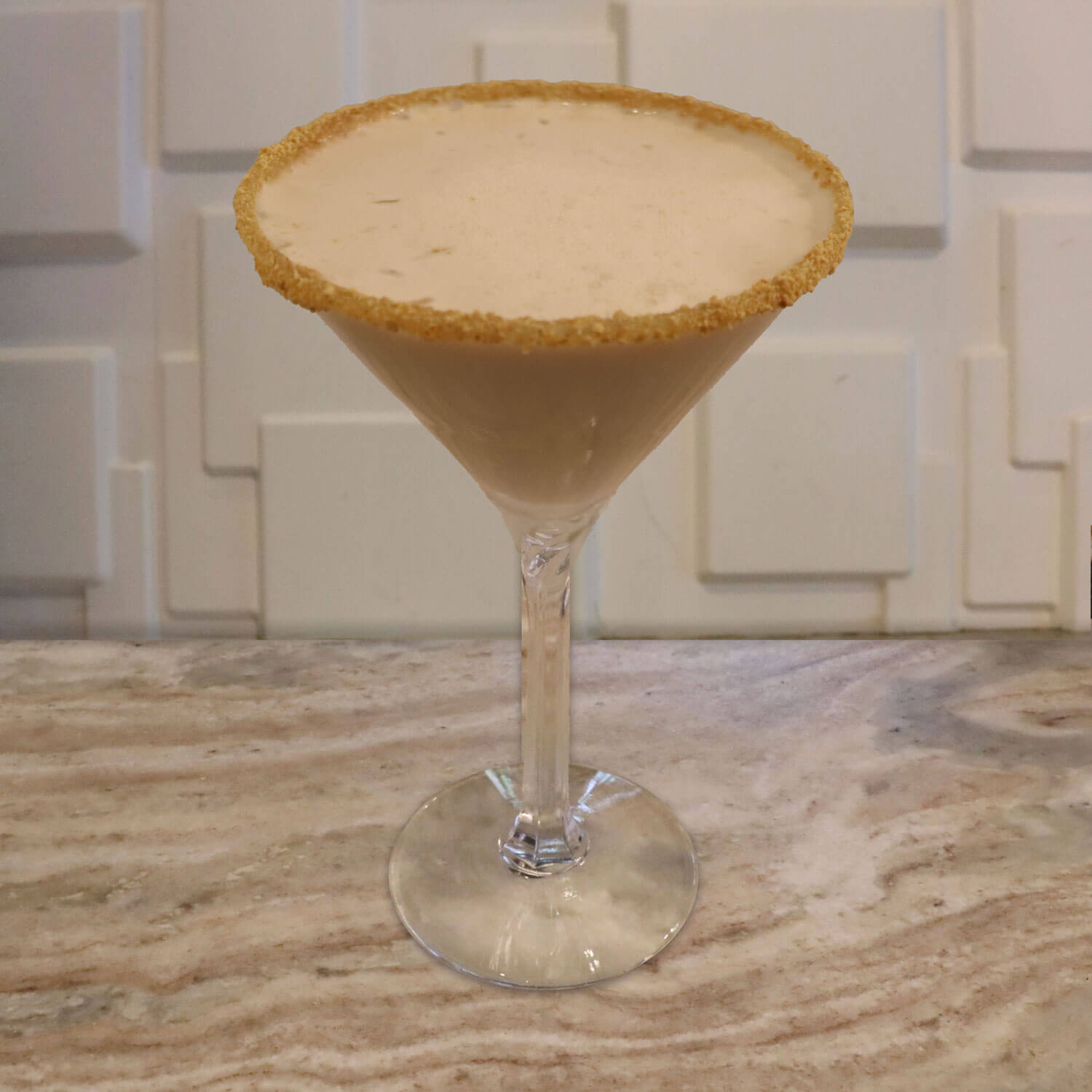 Cake Vodka, Crème De Banana, Irish Cream. Garnished with A Caramel and Graham Cracker Rim