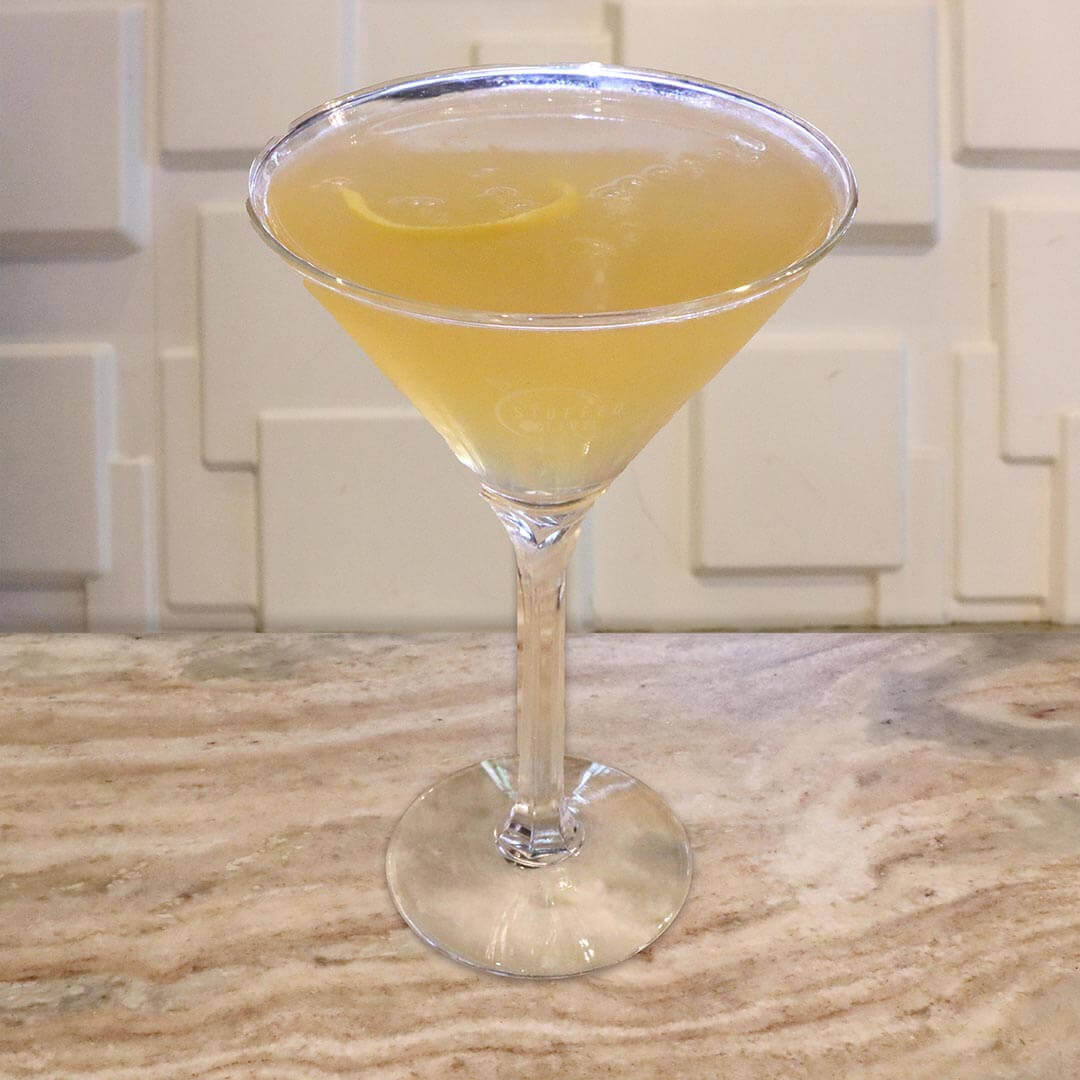 A bright, clear yellow honey-colored cocktail.