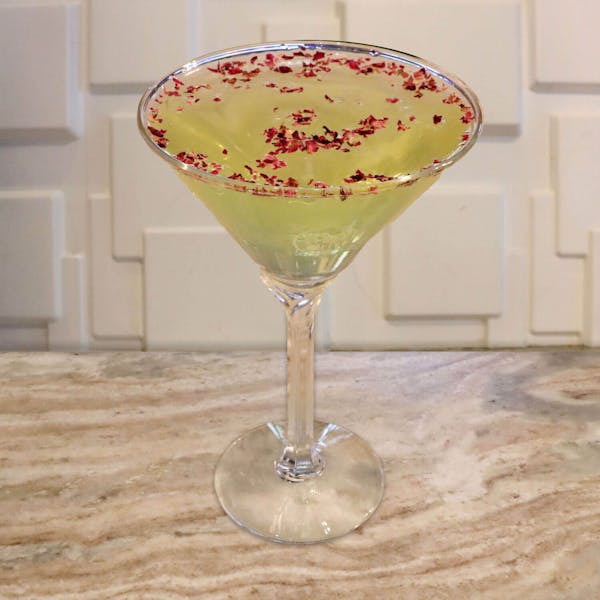 Absolut Pear Vodka, Apple Pucker, Drambuie, St. Germain, Sugar-Free Redbull. Garnished With Edible Rose Petals