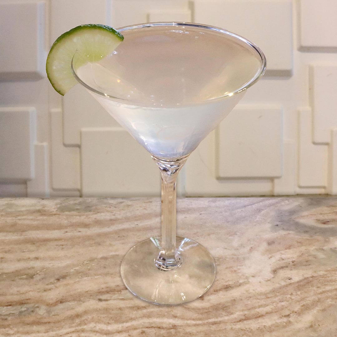 A clear and refreshing cocktail garnished with a fresh lime wheel.