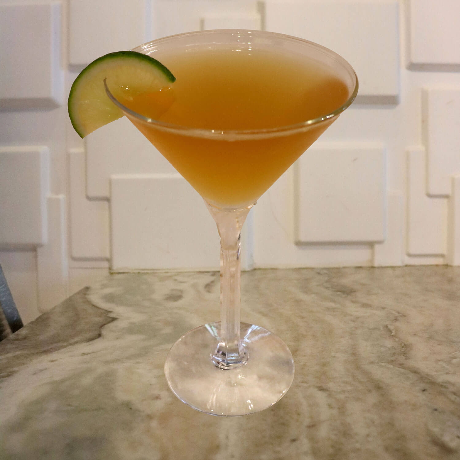 Jose Cuervo Tequila, Amaretto, and Sour. Garnished With a Lime Slice