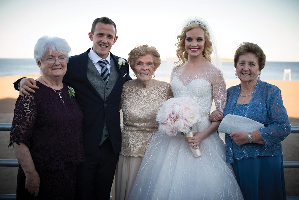 a person standing in front of a group of people posing for the camera