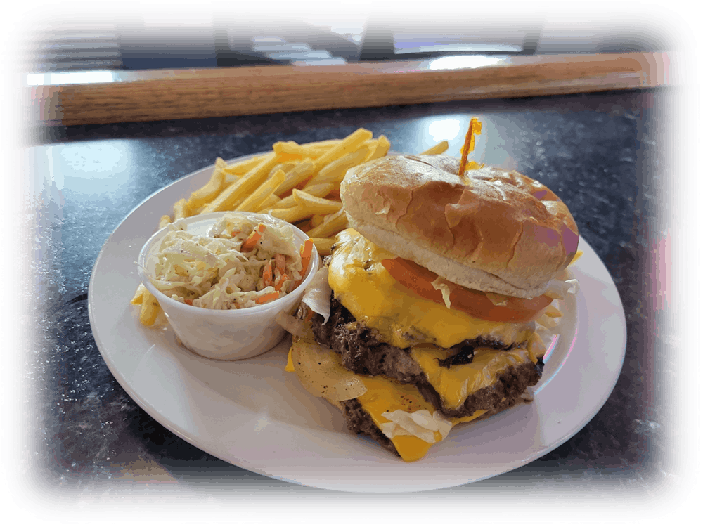 a sandwich sitting on top of a plate of food on a table