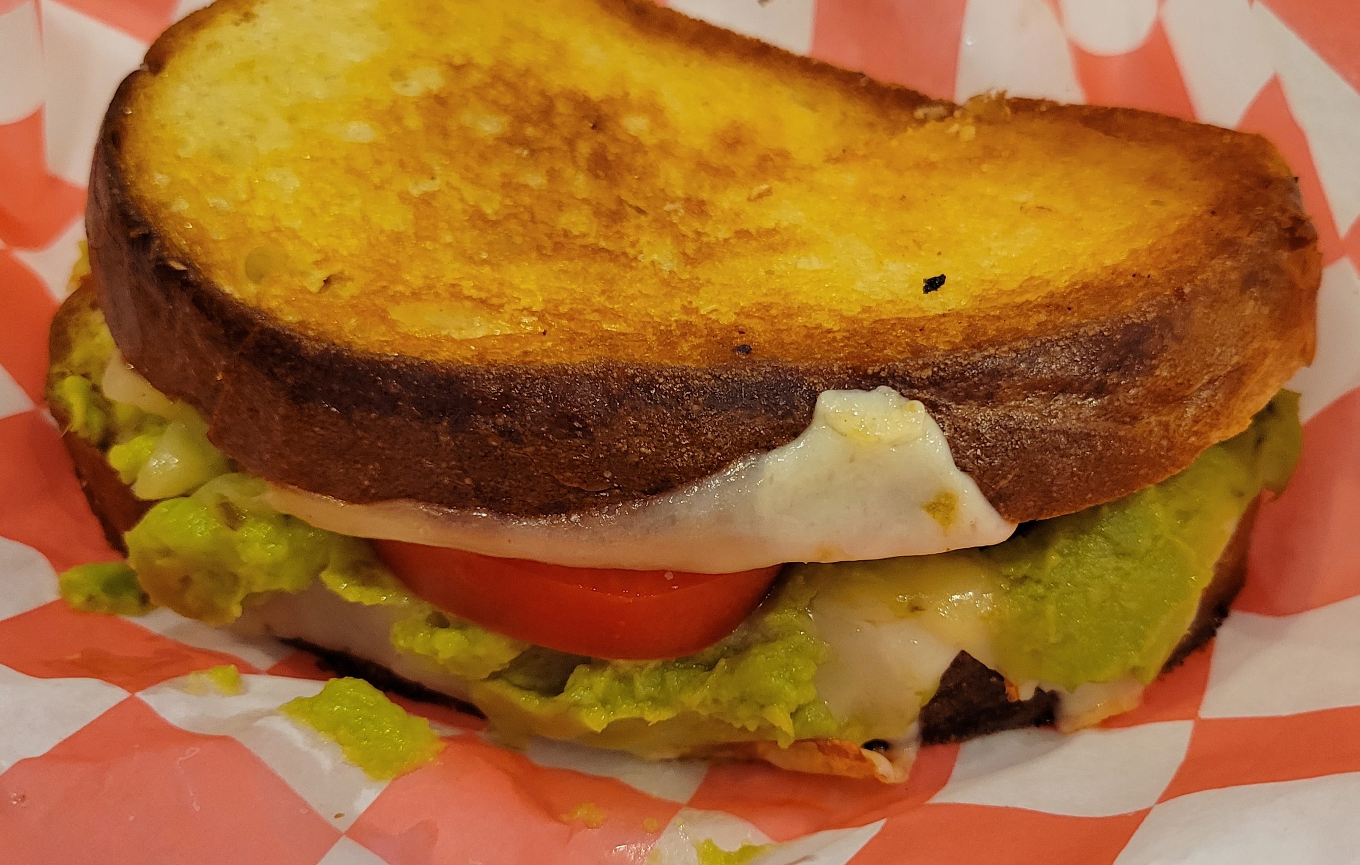 a close up of a sandwich sitting on top of a paper plate