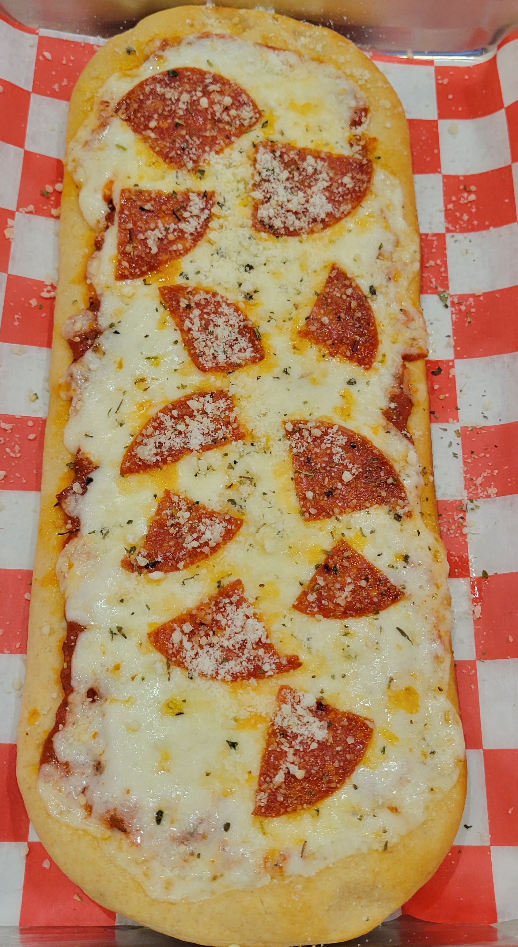 a pepperoni pizza sitting on top of a table