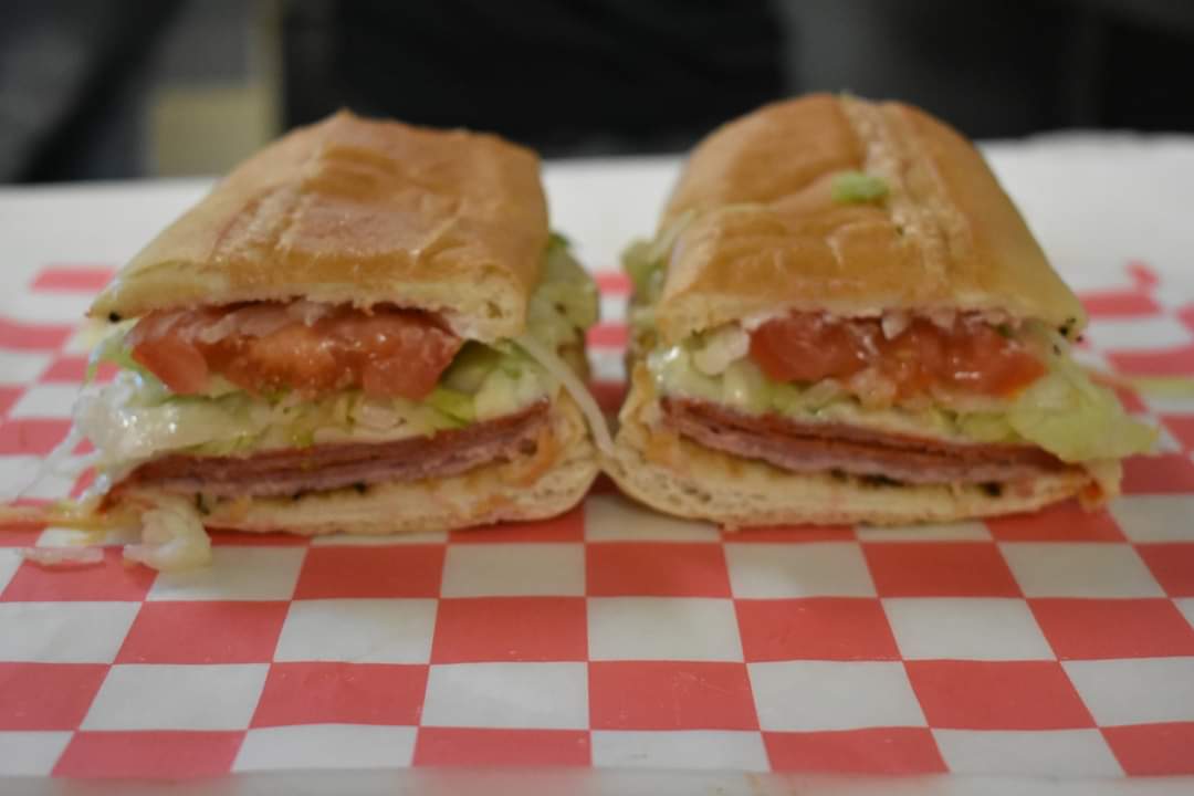 a sandwich sitting on top of a paper plate