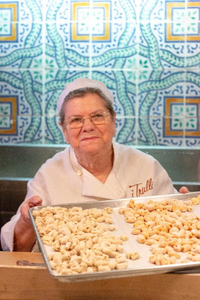 a man sitting at a table with a plate of food