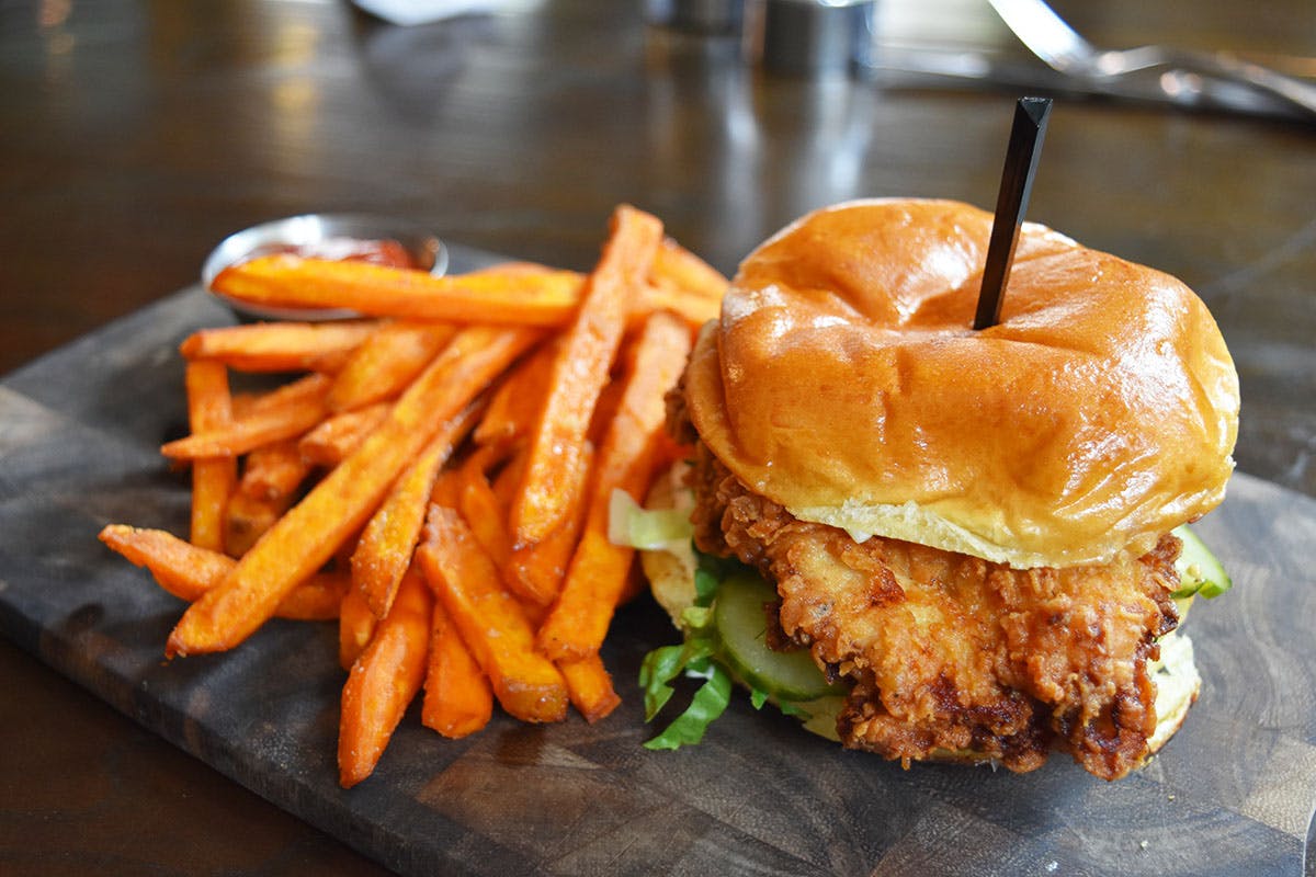 a sandwich sitting on top of a pile of fries