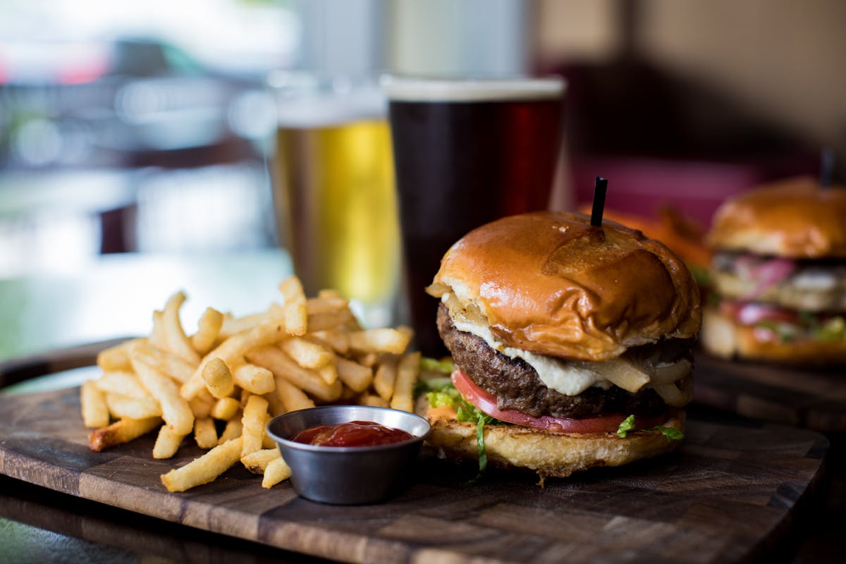 a close up of a sandwich and fries on a plate