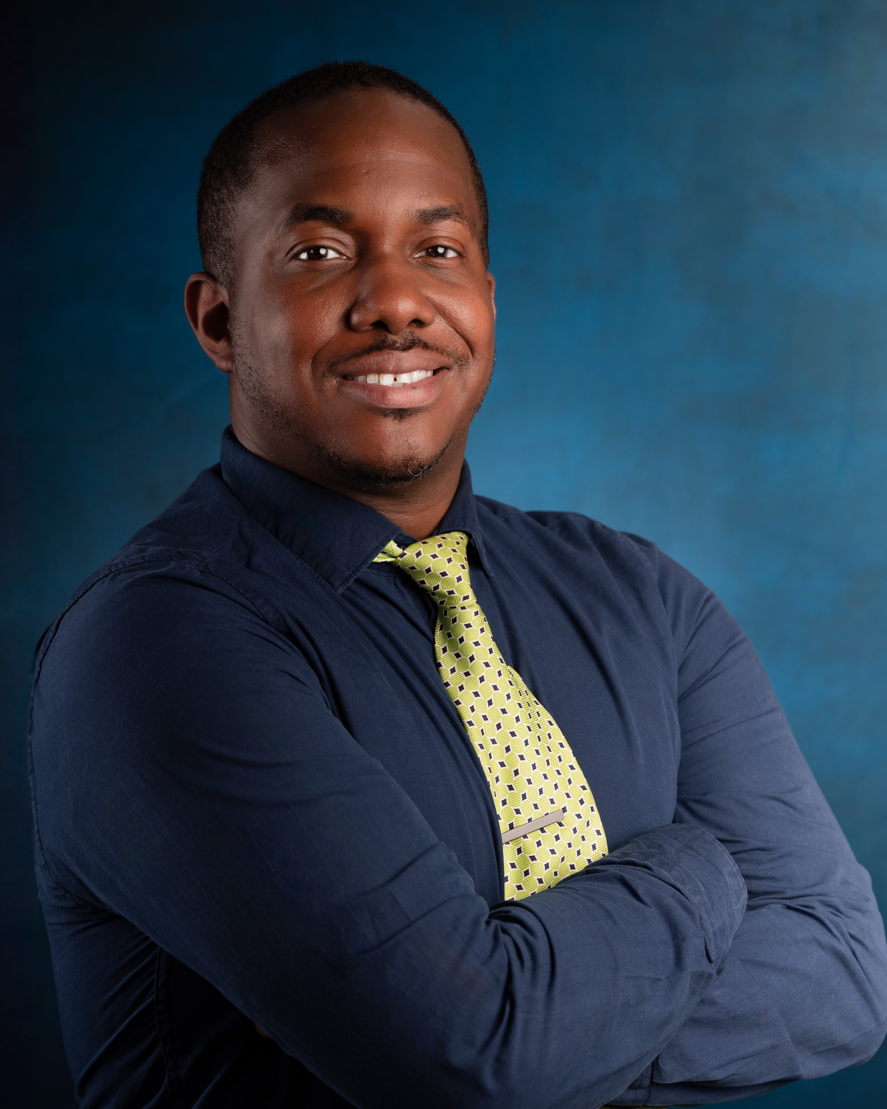 a man wearing a tie and smiling