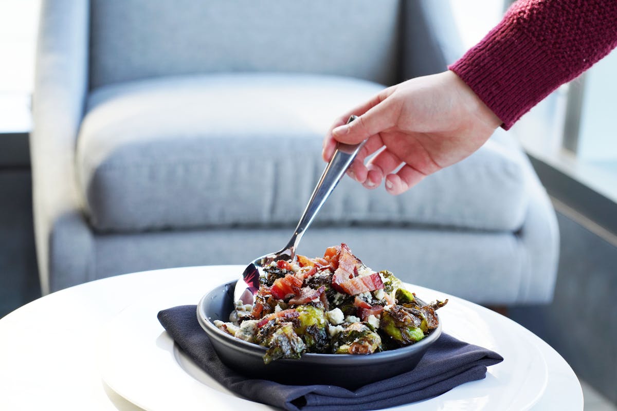 a person sitting at a table with a plate of food