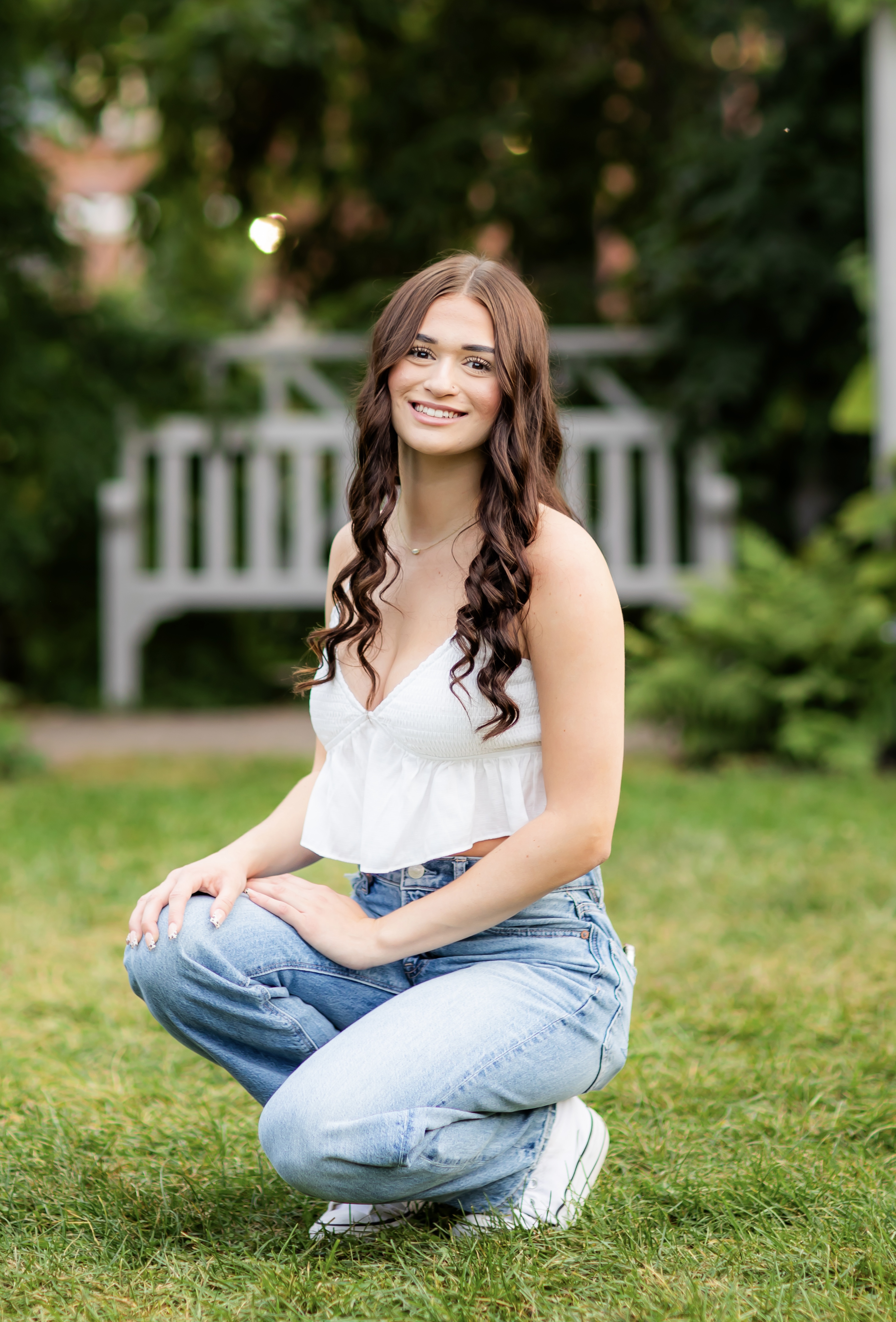 a young girl is sitting in the grass