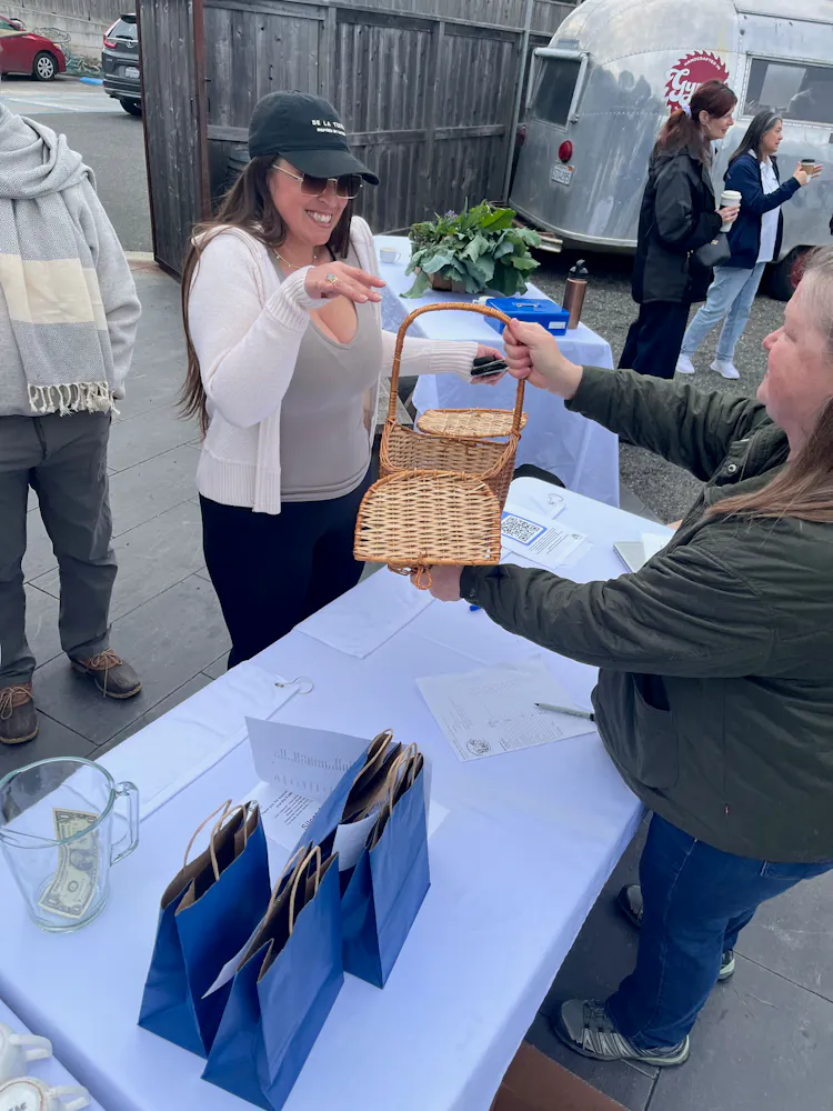 a woman handing a basket to a woman