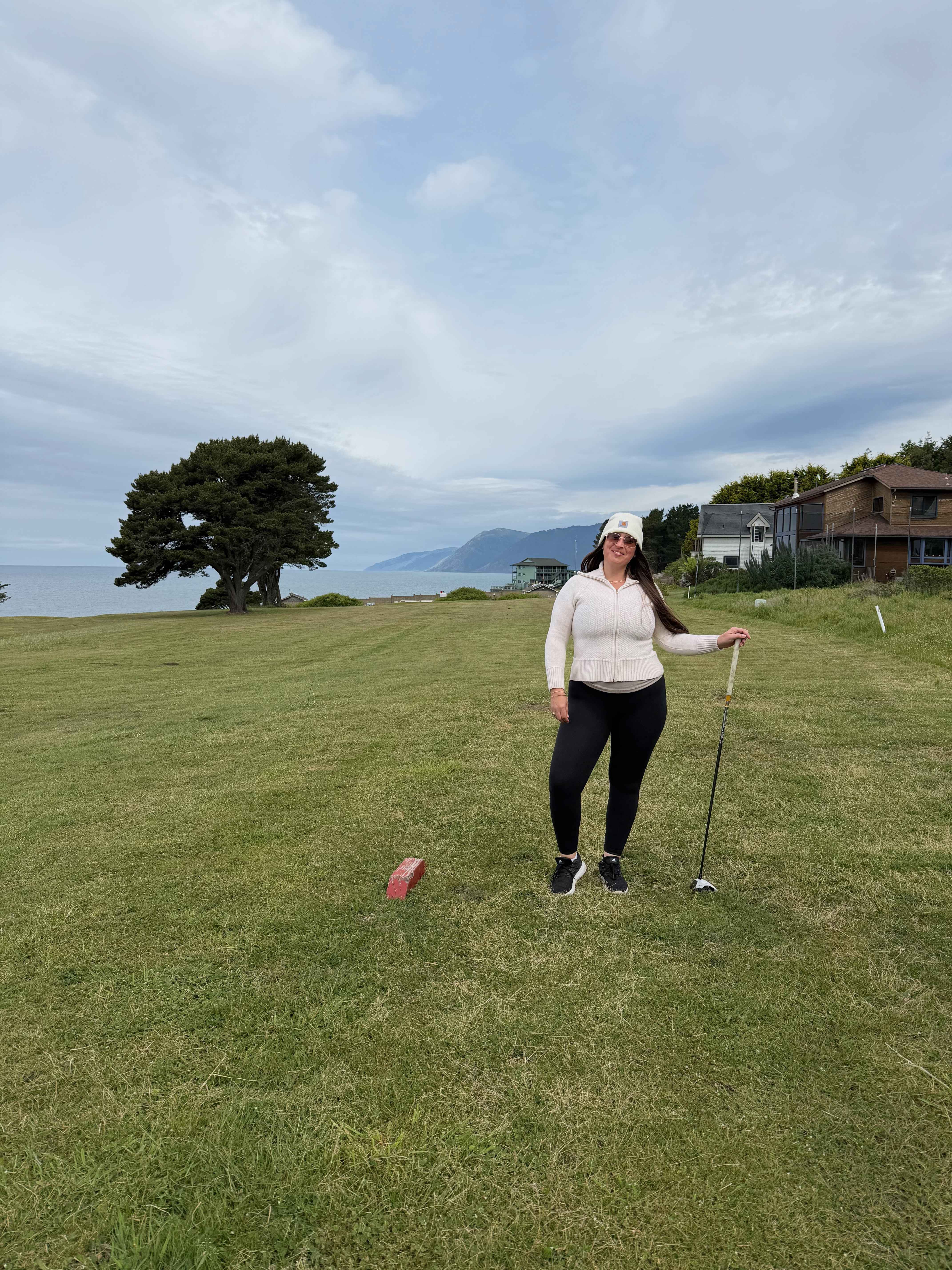 a woman standing on a golf course