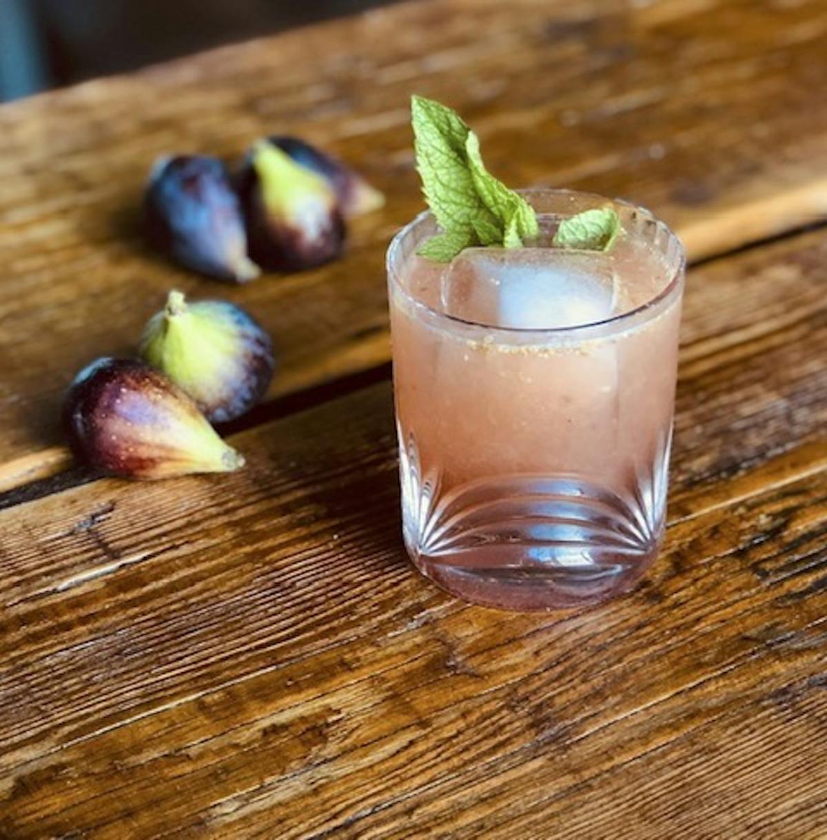 a bird sitting on top of a wooden cutting board