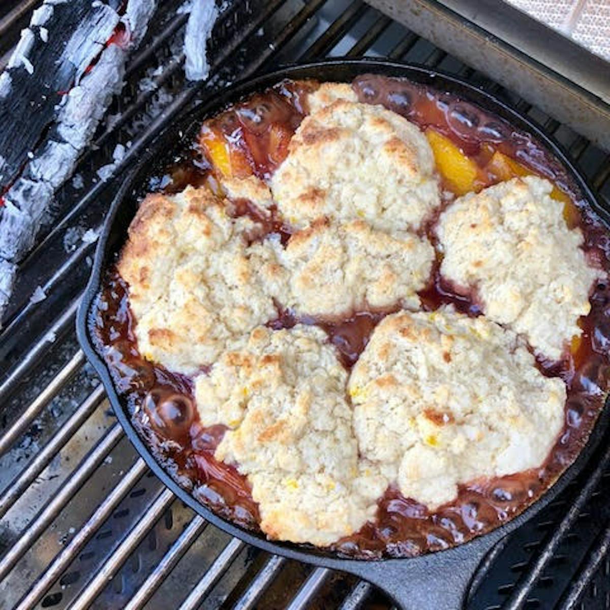 a close up of food on a metal pan on a grill