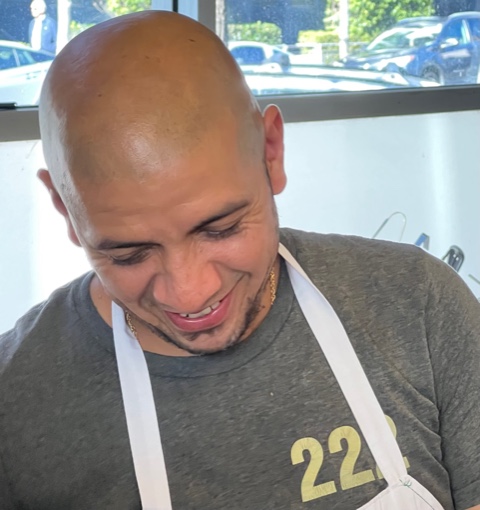a man cutting a cake