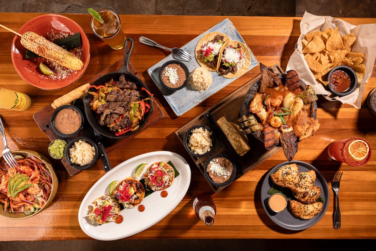 a bunch of food sitting on top of a wooden table