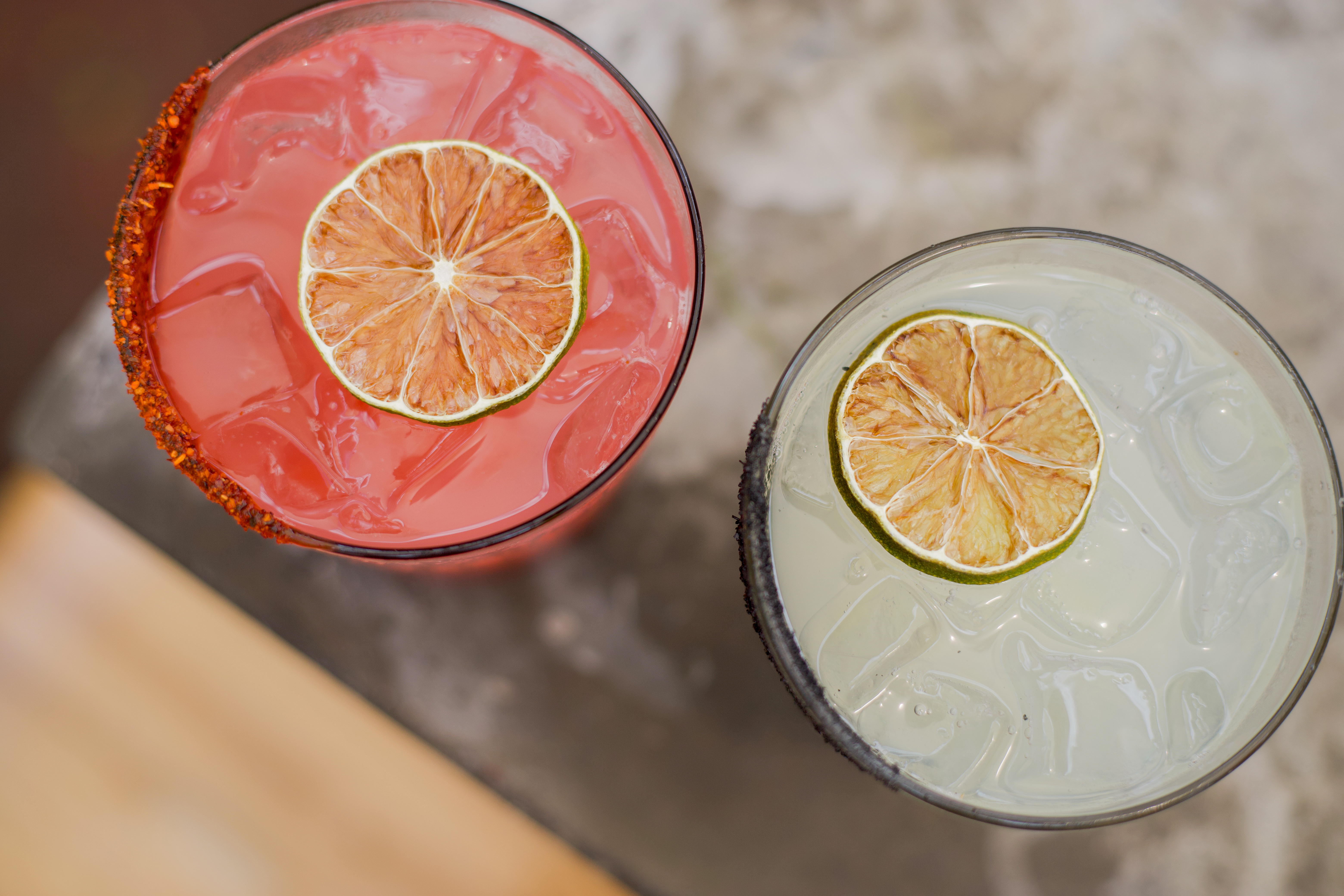 two glasses with drinks on a table