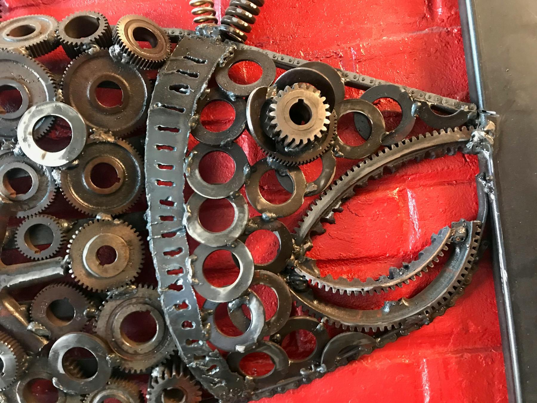 a close up of a red wall with metallic decorations
