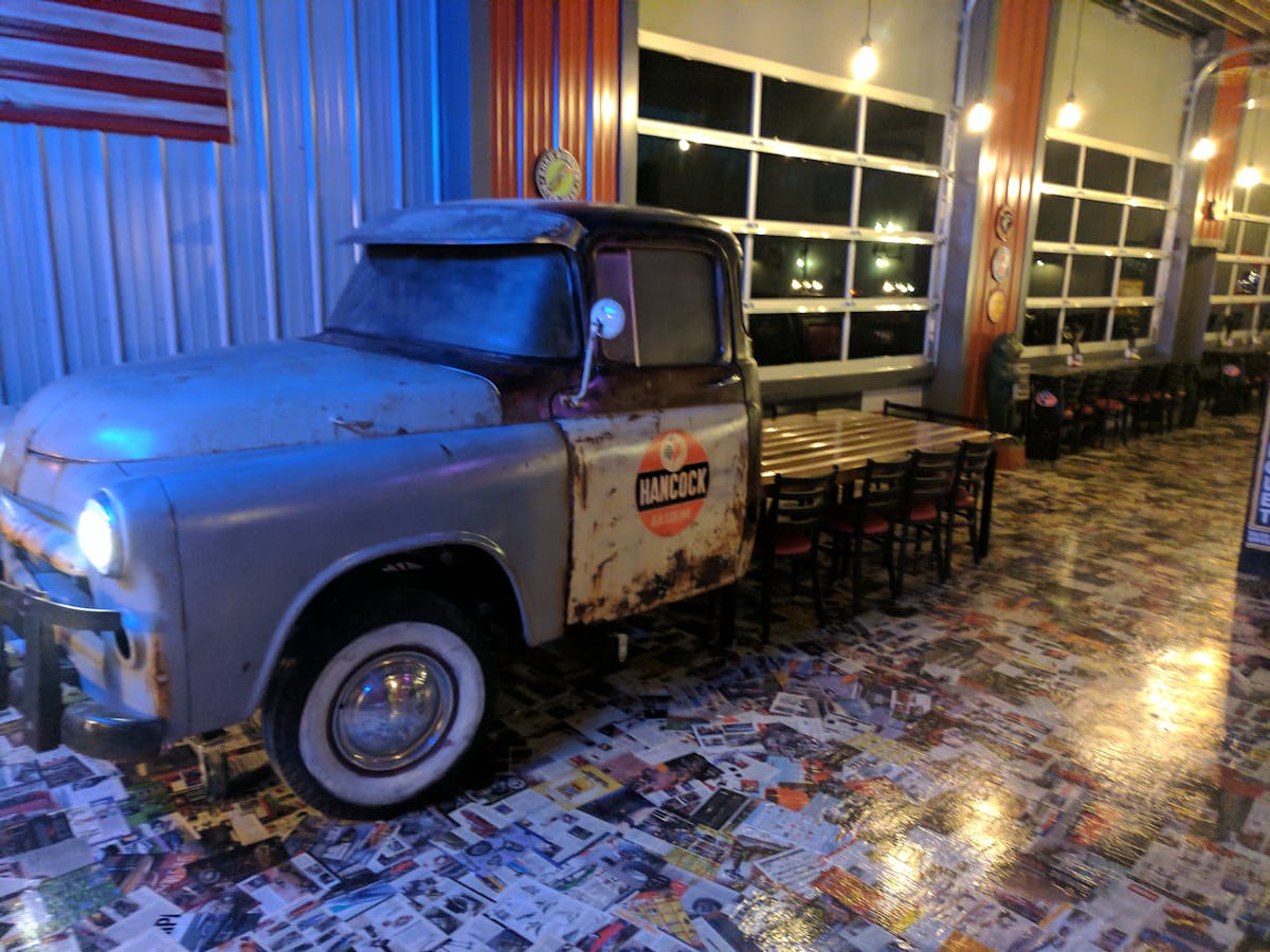 a truck is parked in front of a blue car