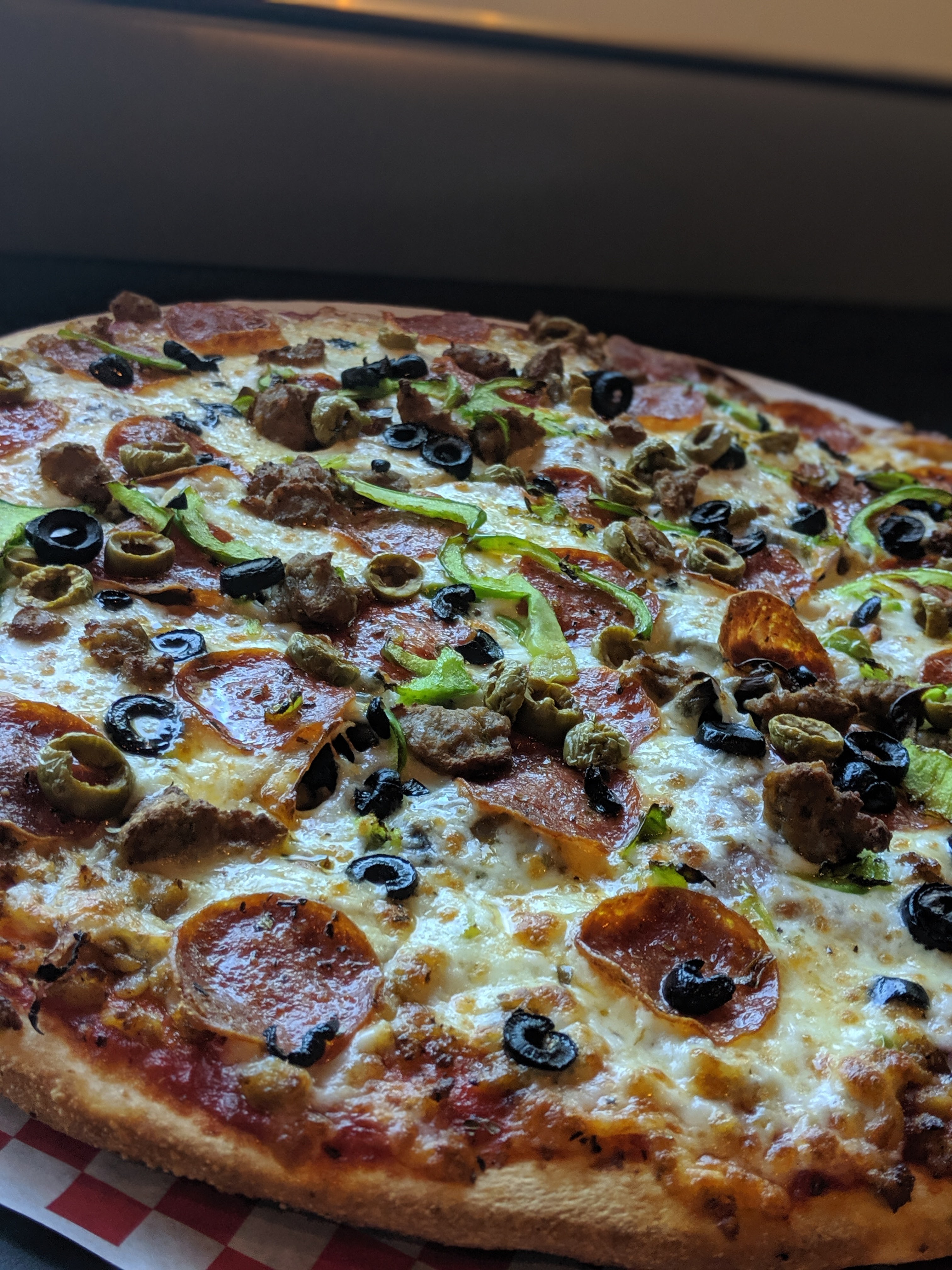 a large pepperoni pizza on a tray