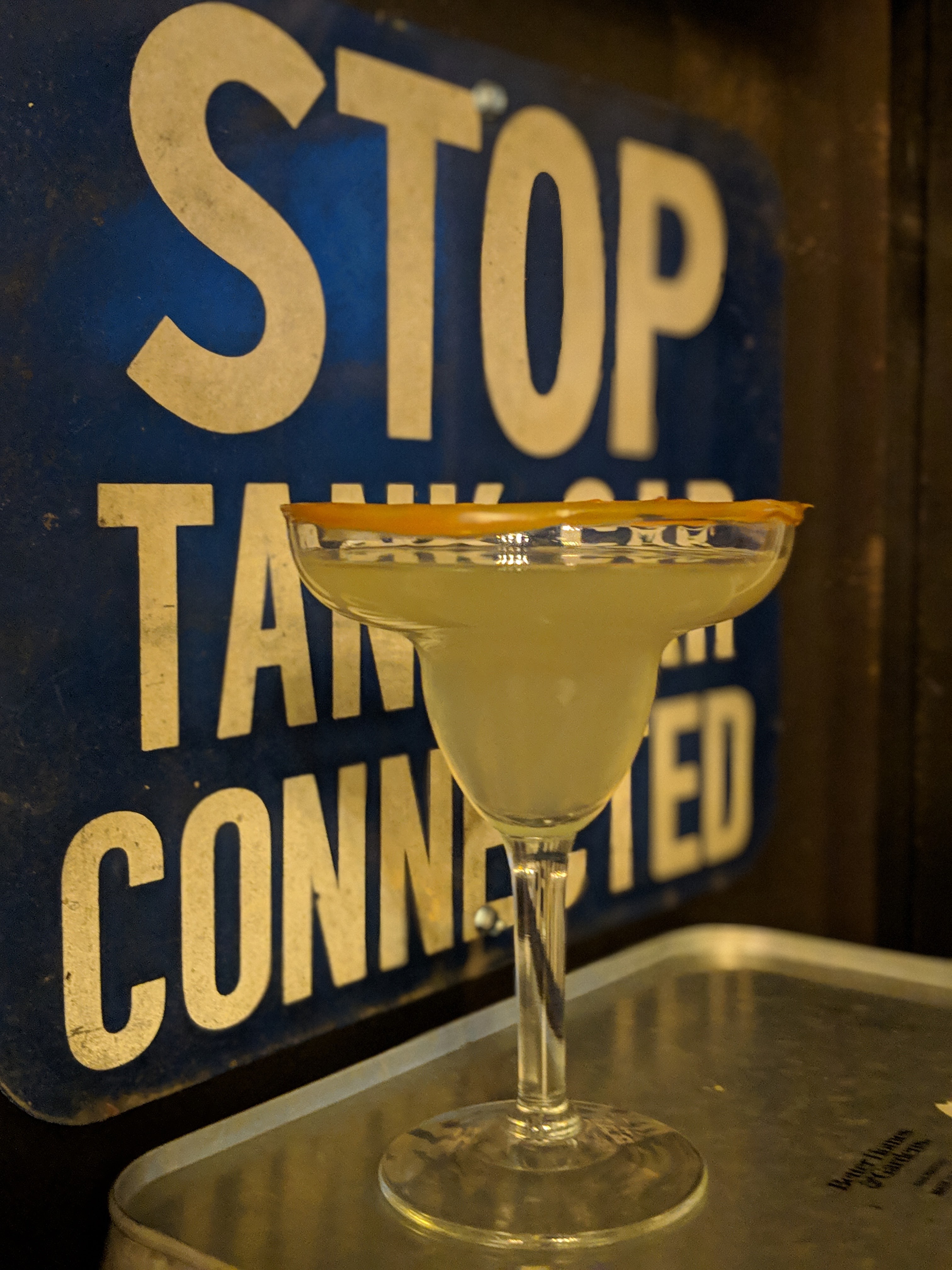 a can of beer in front of a sign