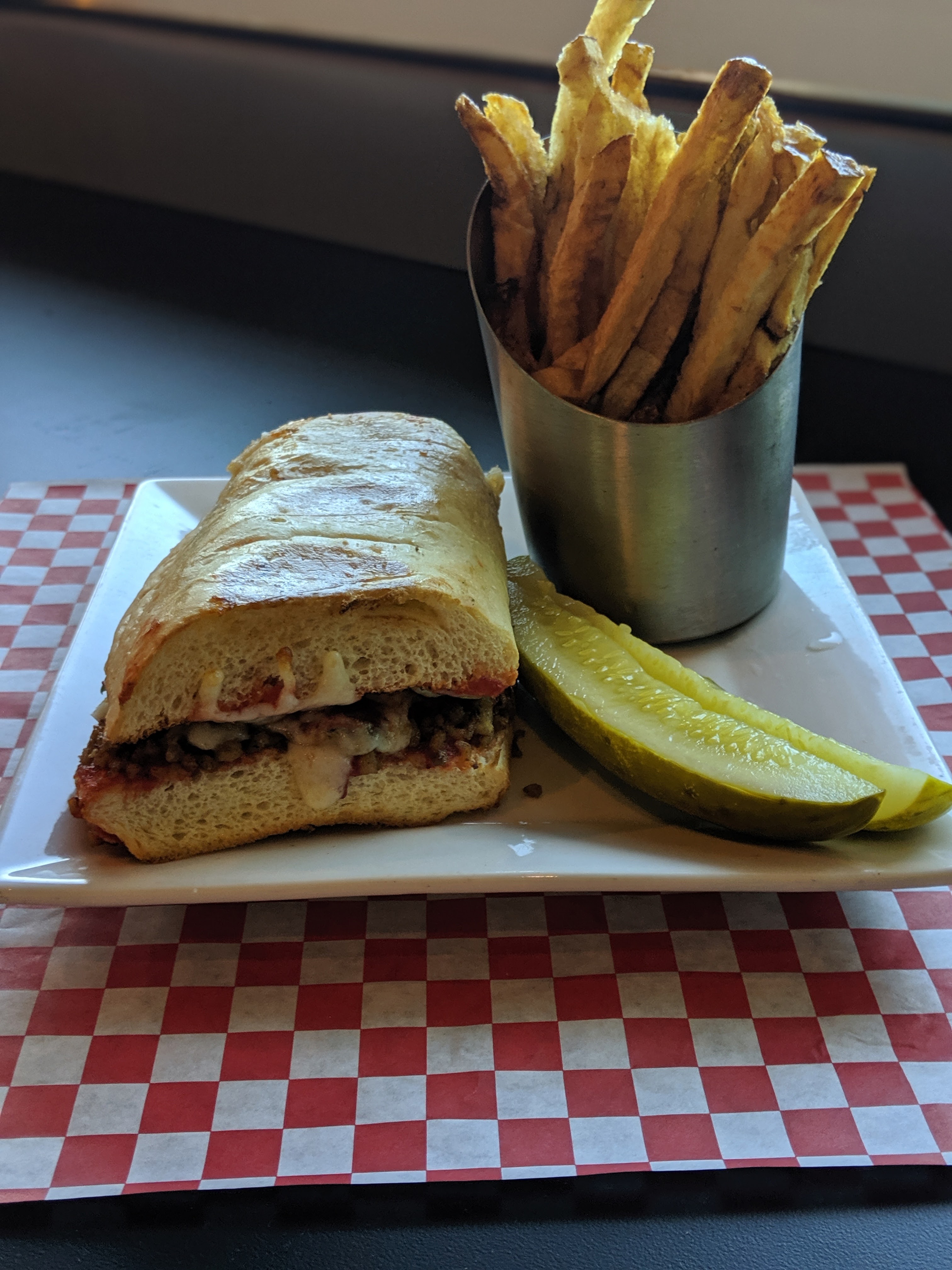 a plate with a sandwich and a cup of coffee