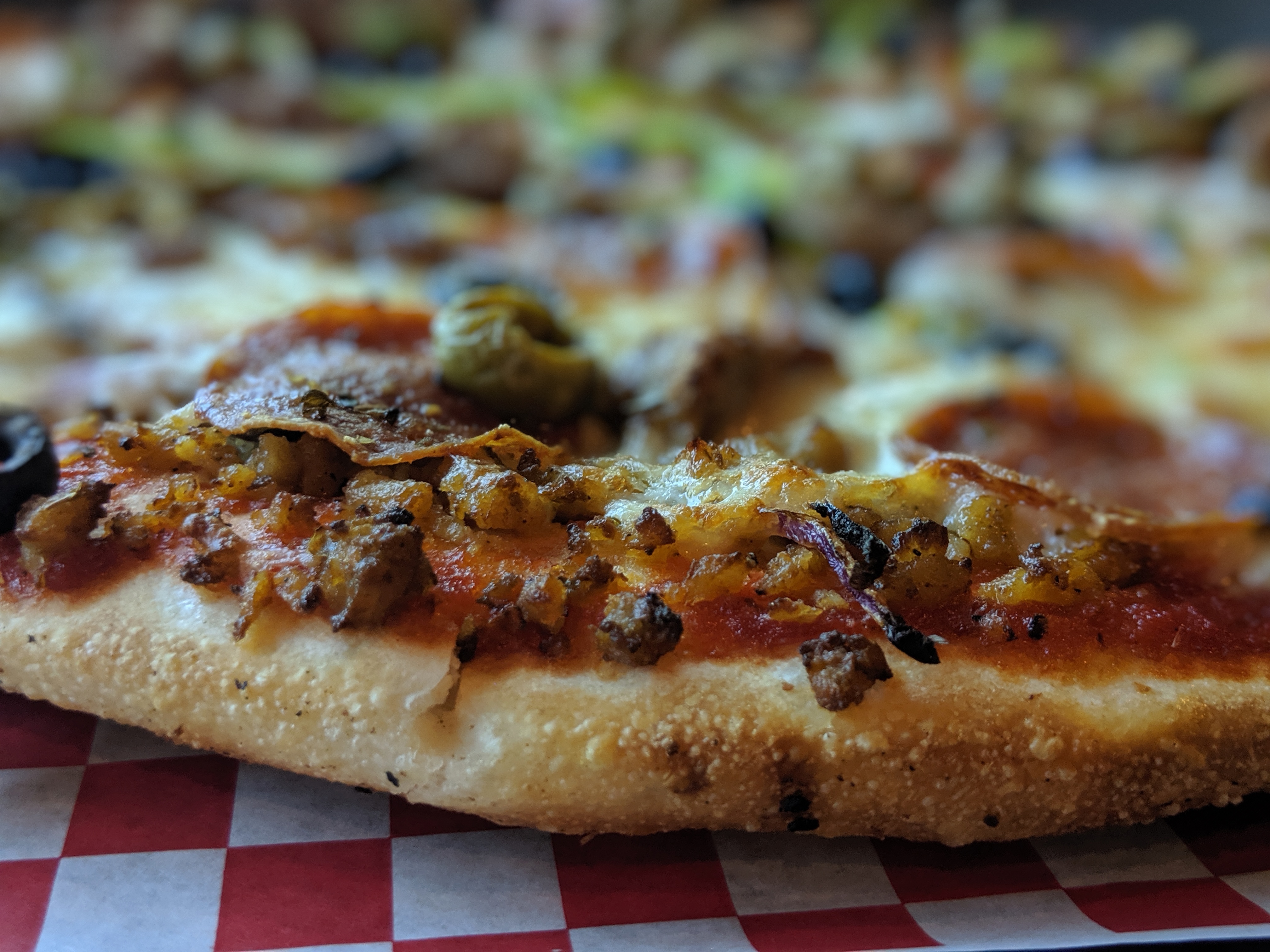 a close up of a slice of pizza