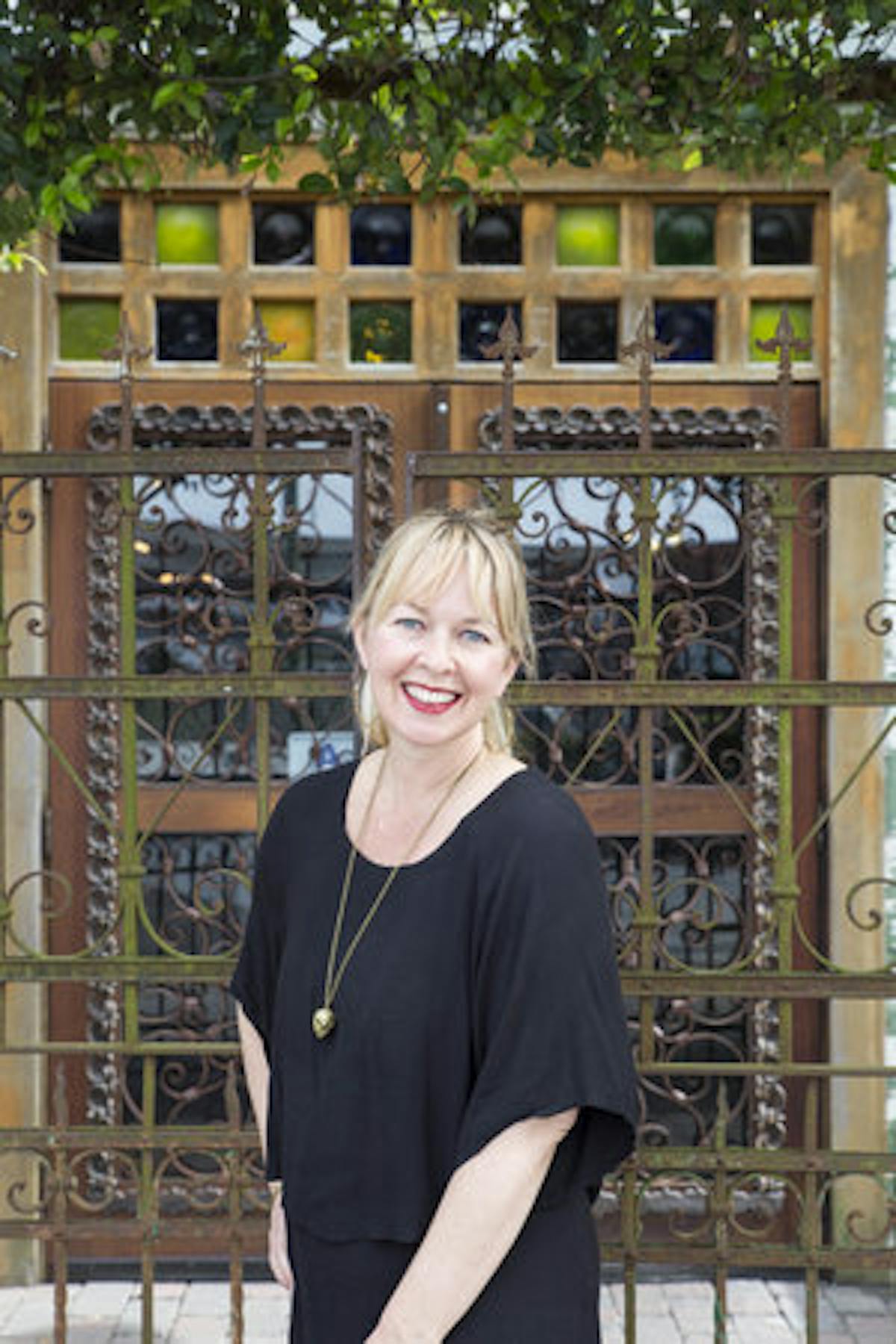 a person standing in front of a fence