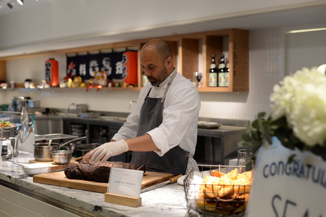 a person standing in a kitchen preparing food