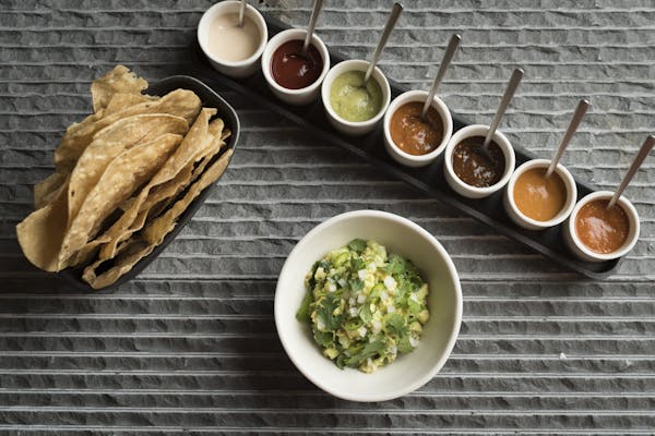 guacamole and tortilla chips with seven salsas