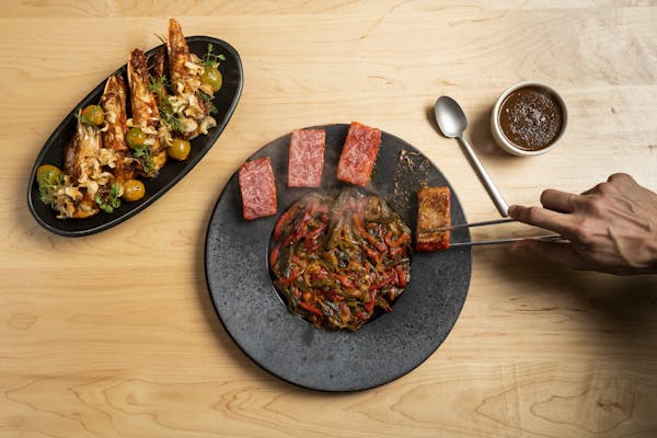 a plate of food sitting on top of a wooden table