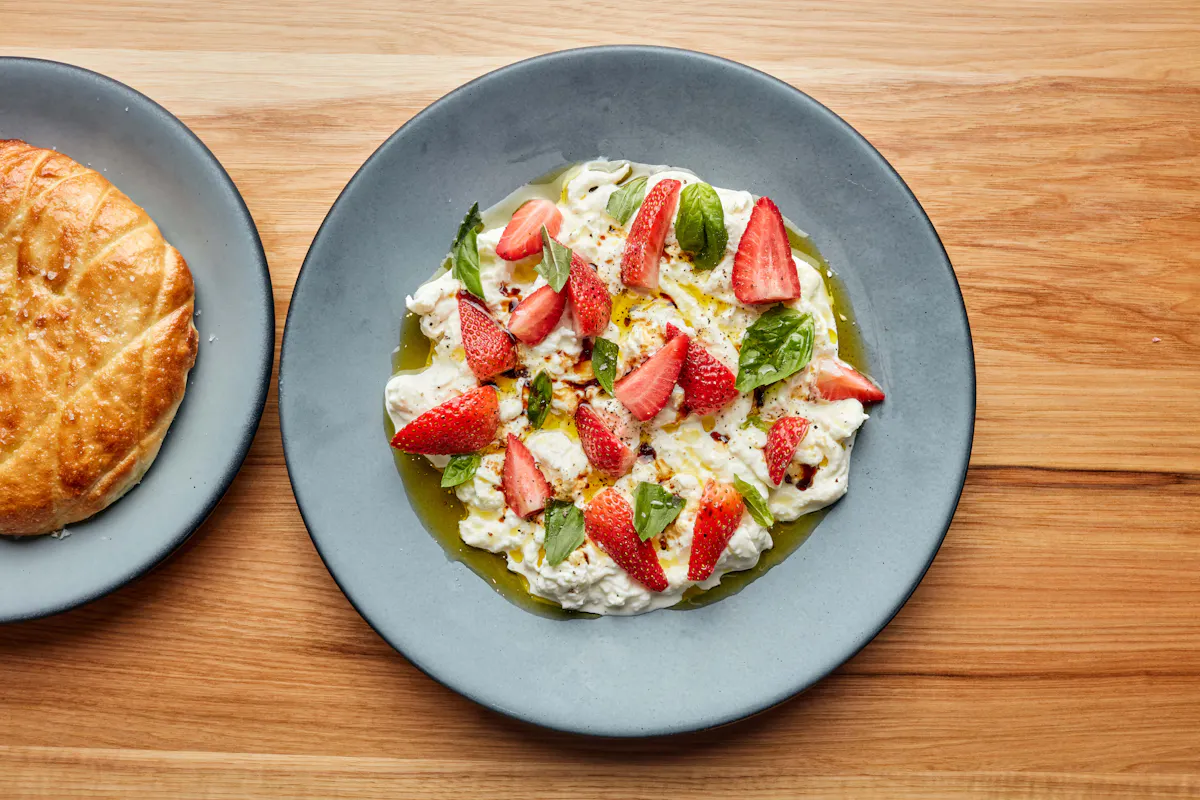 a plate of food sitting on top of a wooden table