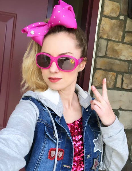 a person wearing a hat and sunglasses