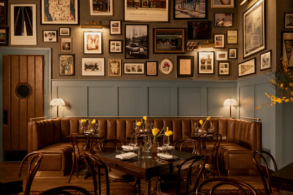 a room with a booth and tables and chairs