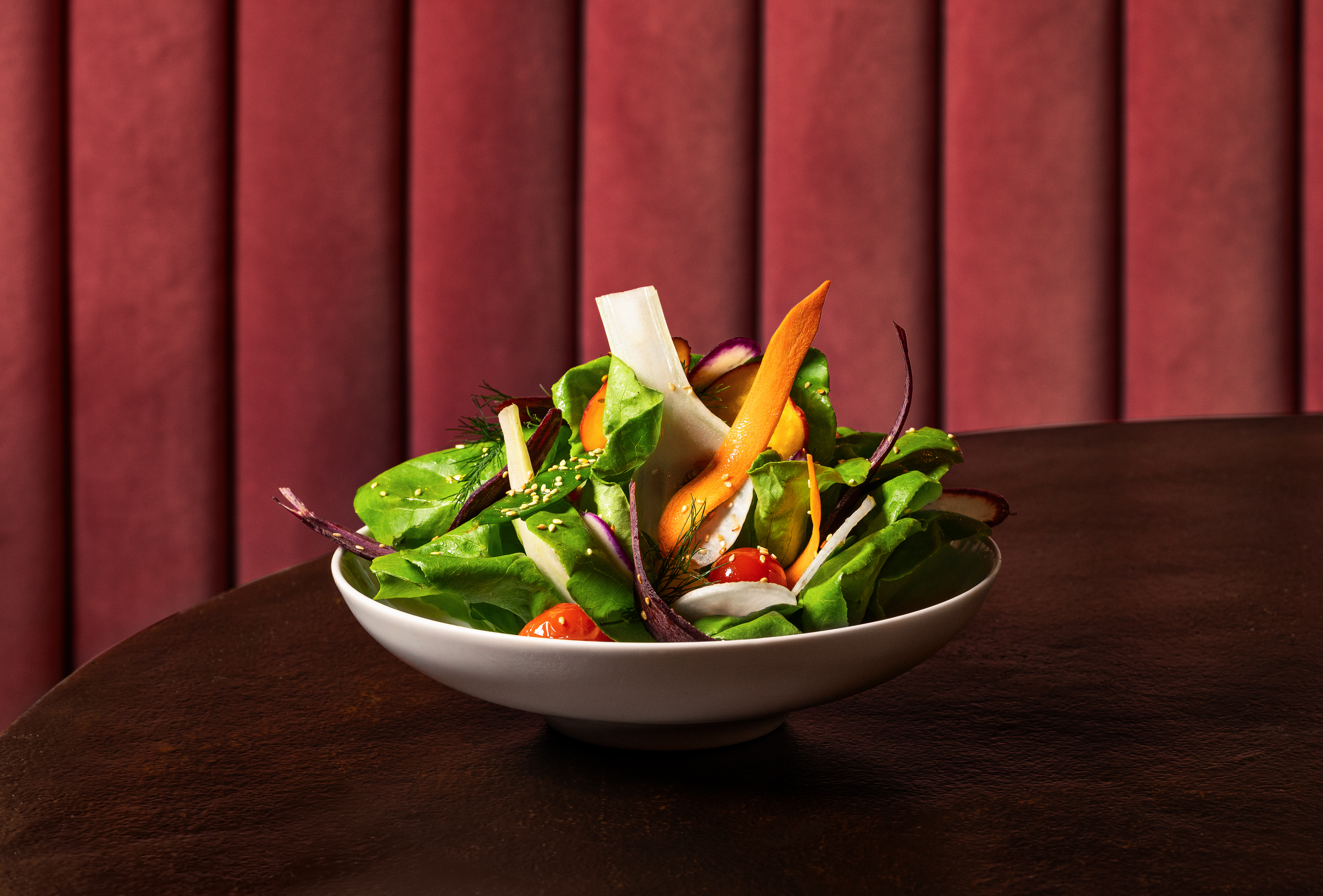 a bowl of fruit sitting on top of a green plant