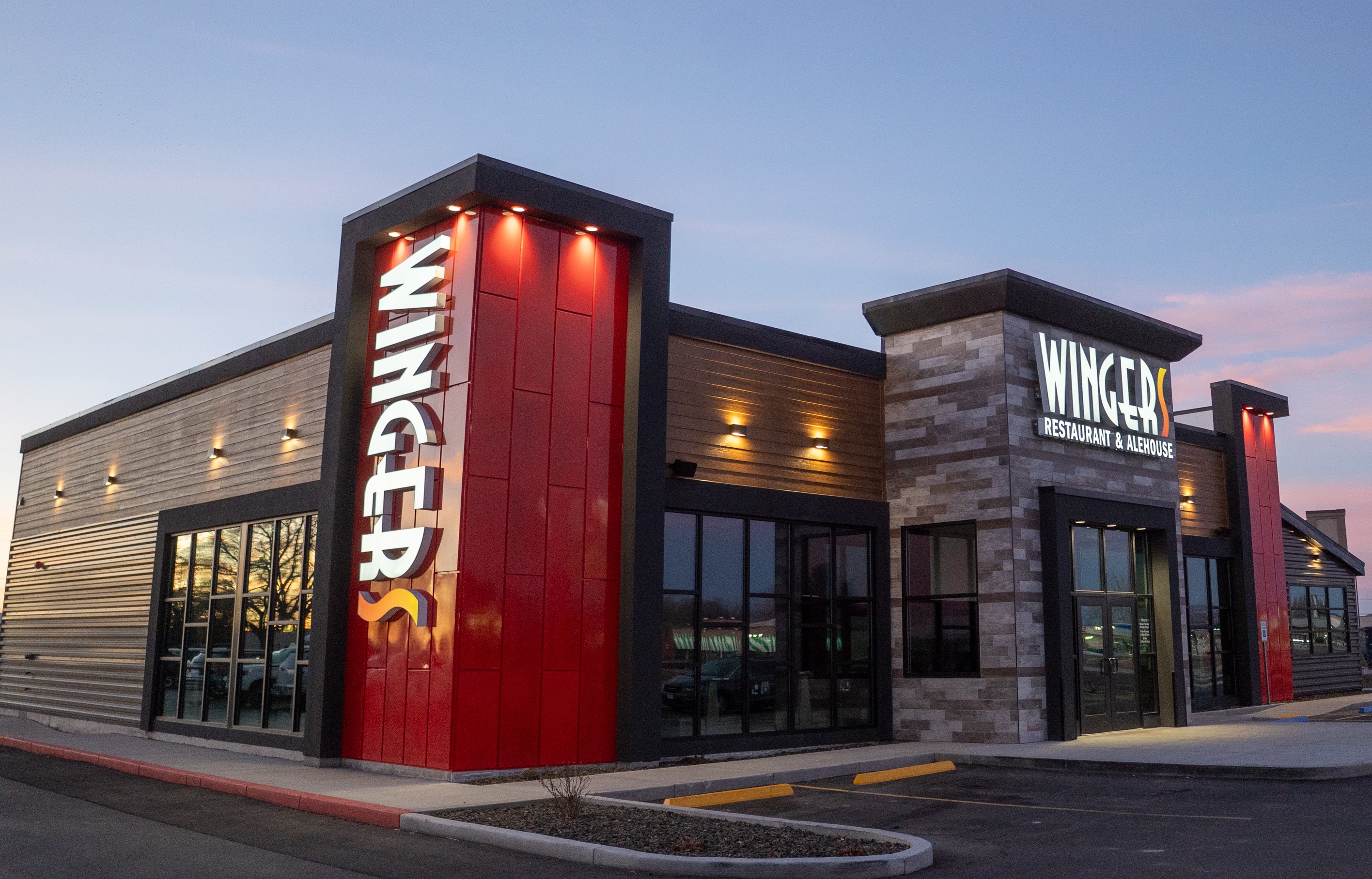 a building with a red wall and a sign