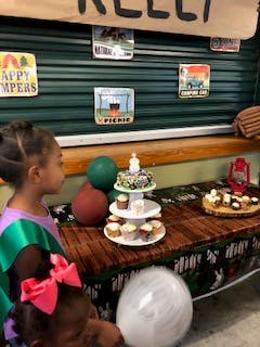 a little girl sitting at a table