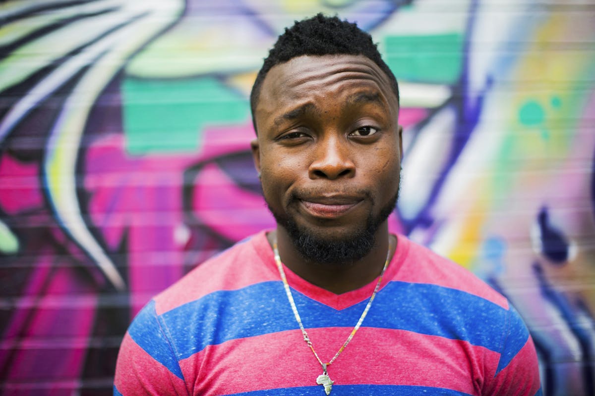a close up of a man in a striped shirt