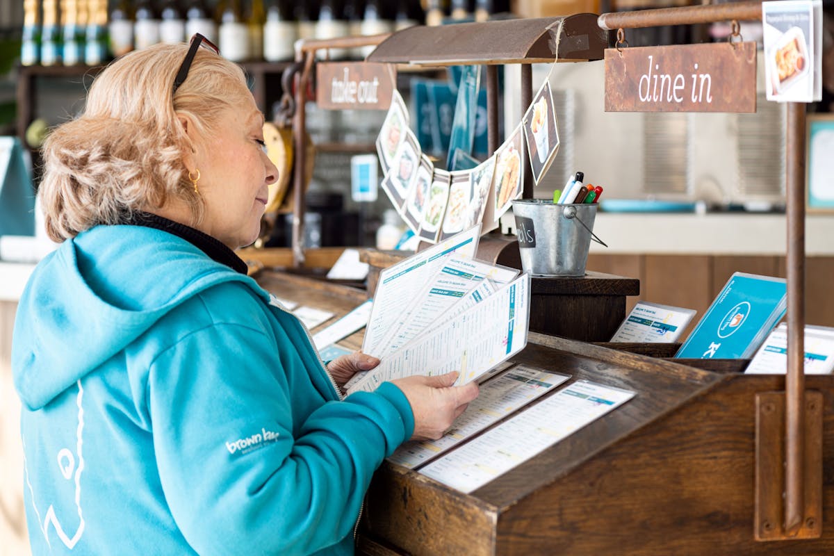 a person sitting at a table using a laptop