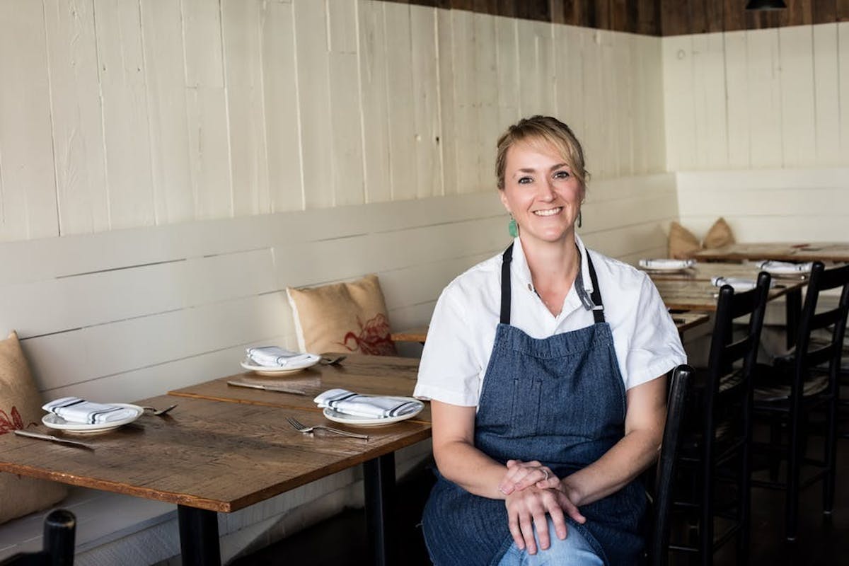 a woman sitting next to a table