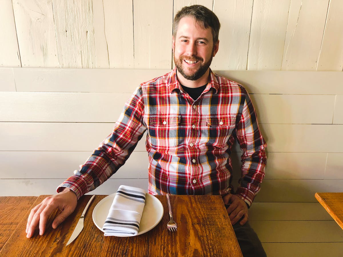 a man sitting on a dining table