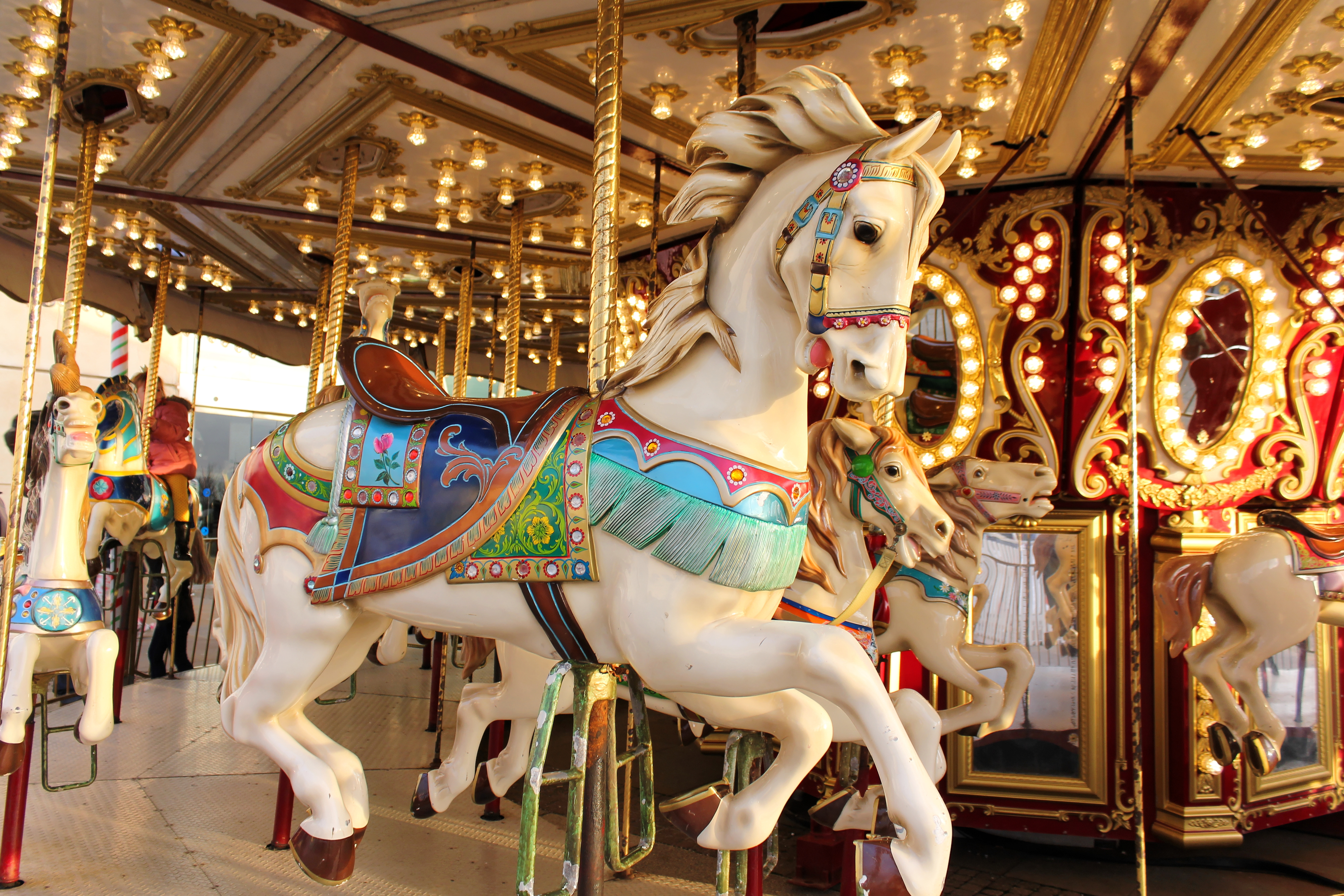 a person standing in front of a carousel