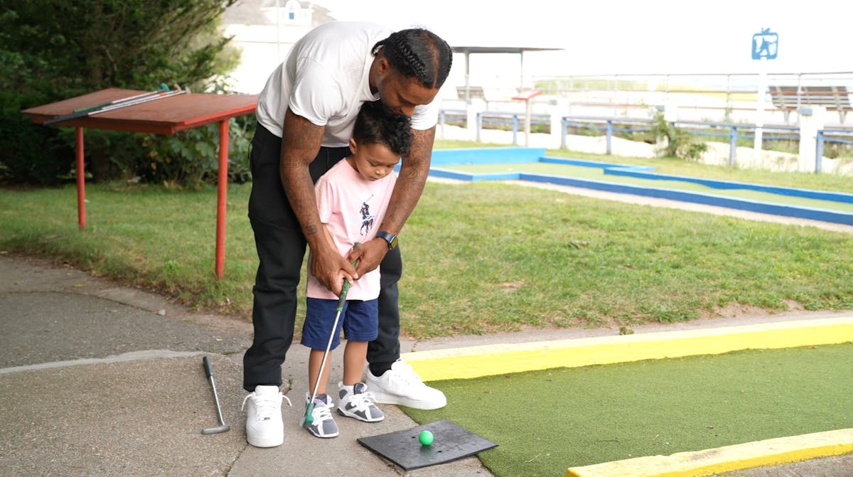 a man that is standing in the grass