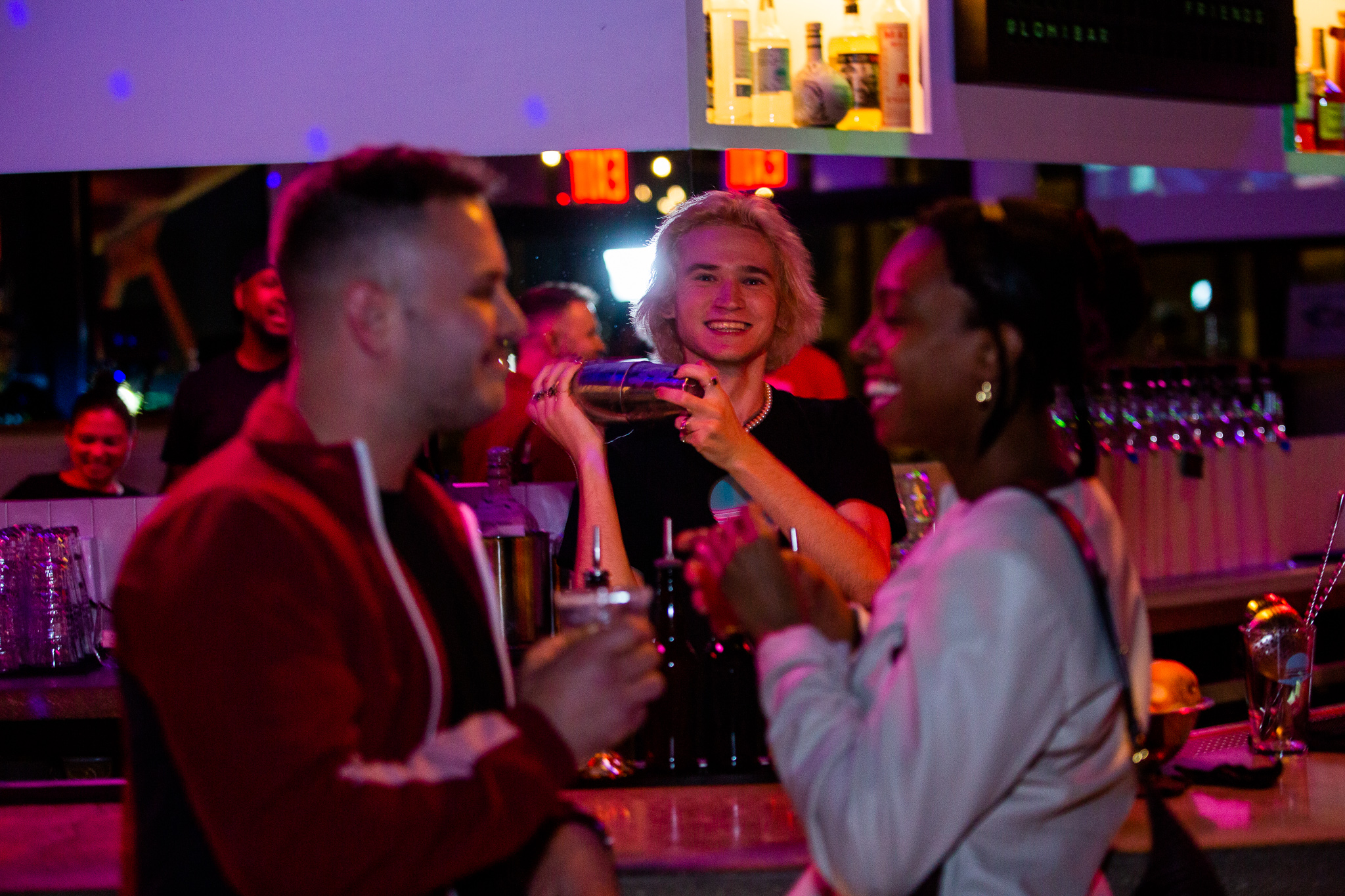 a group of people drinking wine at a bar